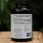 Supplement bottle with label on a woven surface